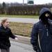 A pedestrian uses a mask to stay warm at the Girls on the Run 5k on Sunday. Daniel Brenner I AnnArbor.com